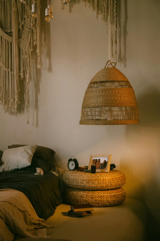 Warm and inviting boho-style bedroom featuring wicker decor, cozy lighting, and textured textiles.