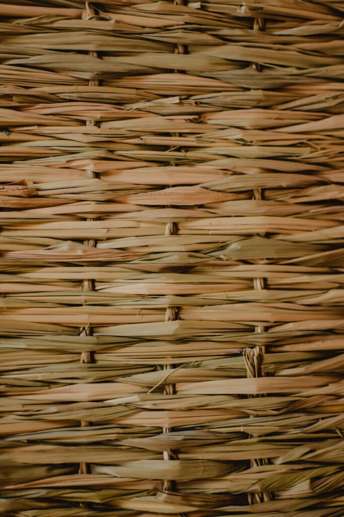 Detailed close-up of woven rattan showcasing intricate texture and pattern in warm tones.